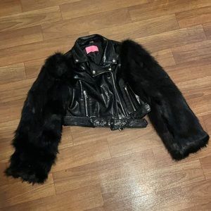 A black faux leather with faux fur sleeves and zipper details